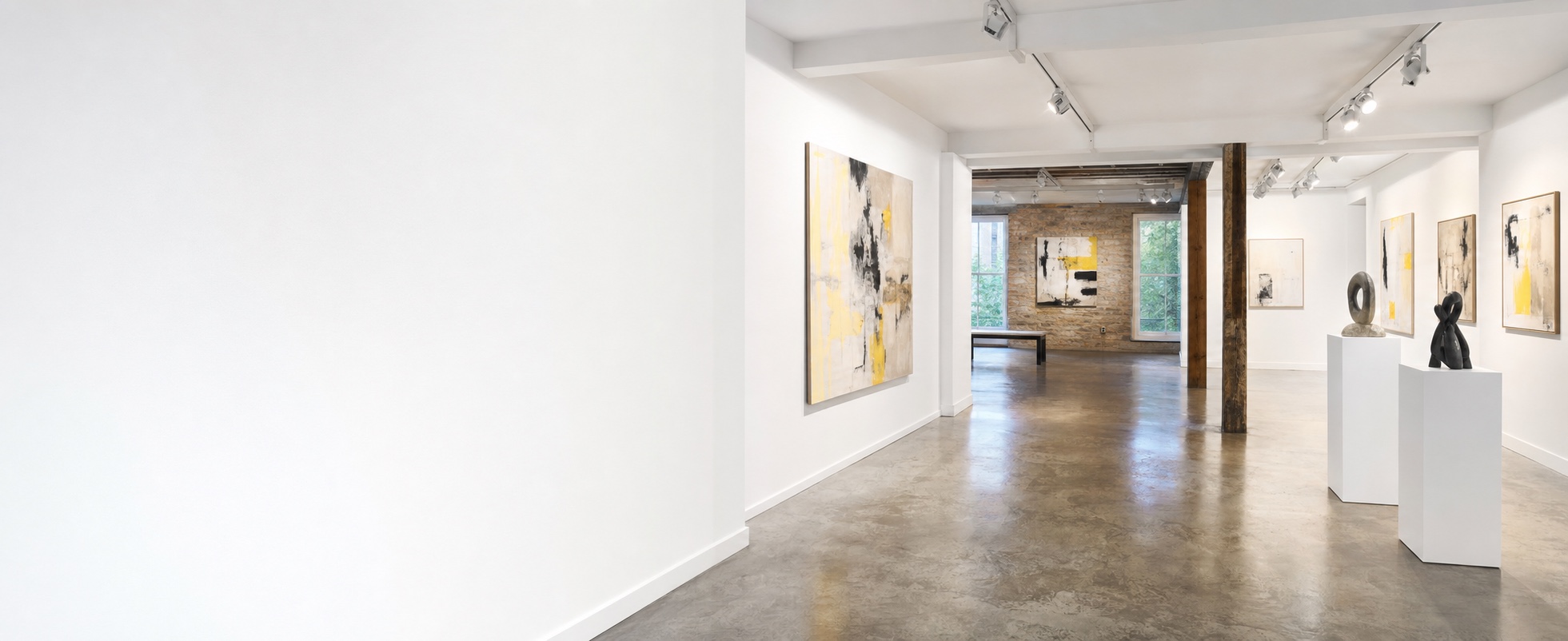 Contemporary independent gallery with artwork, track lighting and sculpture plinths